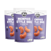 Three packages of Memphis Style BBQ Cashews on a white background