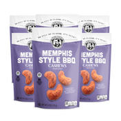 Three packages of Memphis Style BBQ Cashews on a white background
