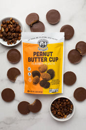 Packaging of peanut butter cup flavored peanuts with product around on a marble surface