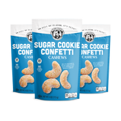 Three packages of Sugar Cookie Confetti Cashews on a white background
