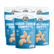 Three packages of Sugar Cookie Confetti Cashews on a white background