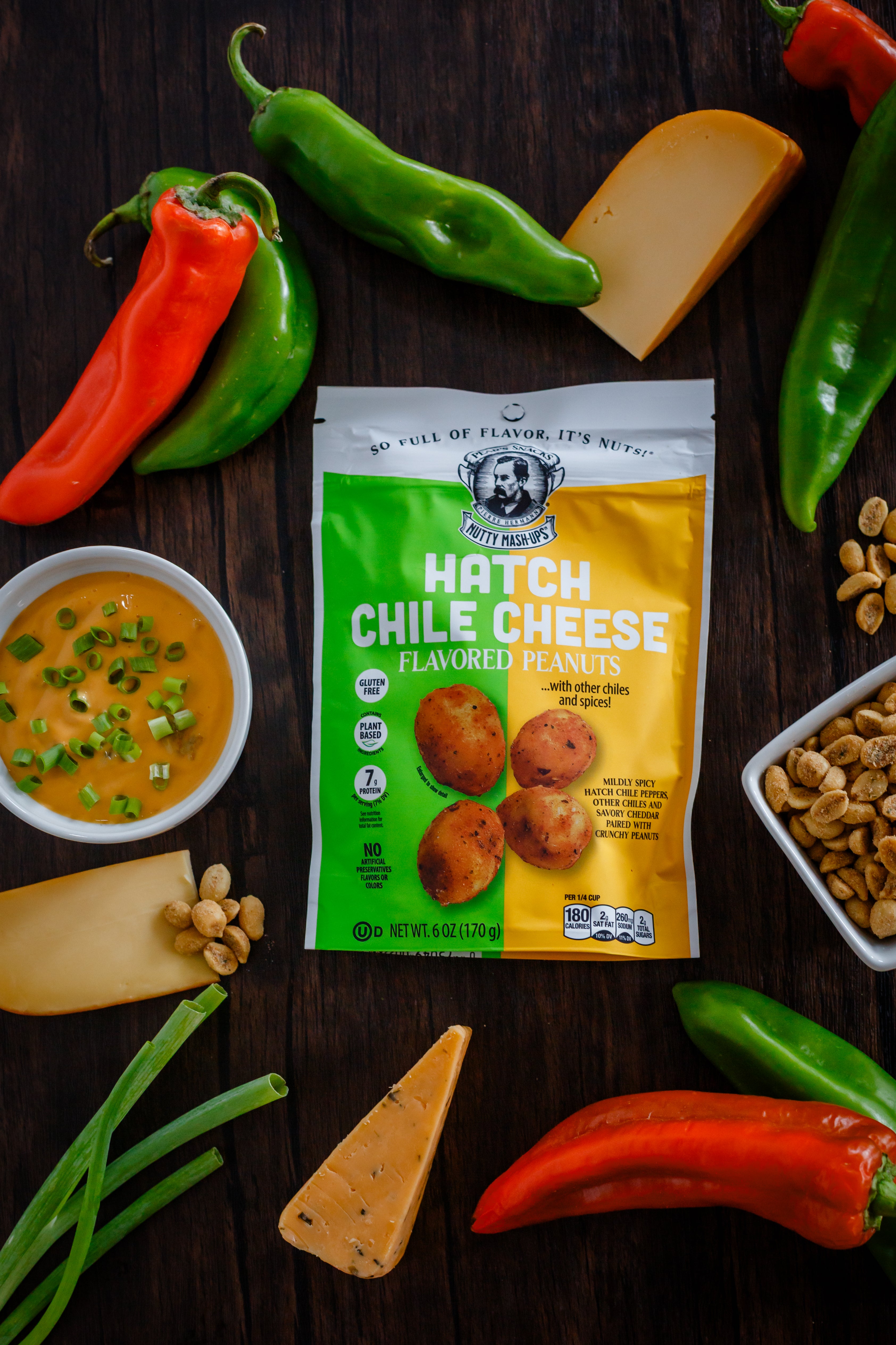 Packaging of Hatch Chile Cheese flavored peanuts with peppers and cheese on a wooden surface